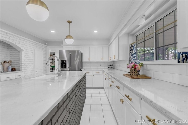 5824 S Louisville Ave, Tulsa, OK 74135 - kitchen featuring high end refrigerator, tasteful backsplash, white cabinetry, crown molding, and hanging light fixtures