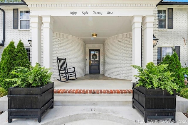 5824 S Louisville Ave, Tulsa, OK 74135 - doorway to property with brick siding and covered porch