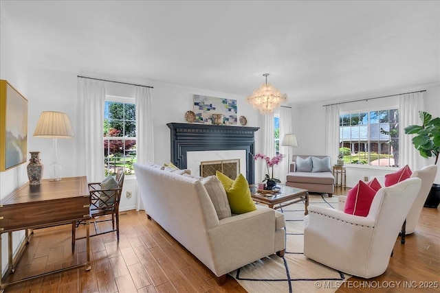 5824 S Louisville Ave, Tulsa, OK 74135 - living area featuring a chandelier, wood finished floors, and a fireplace