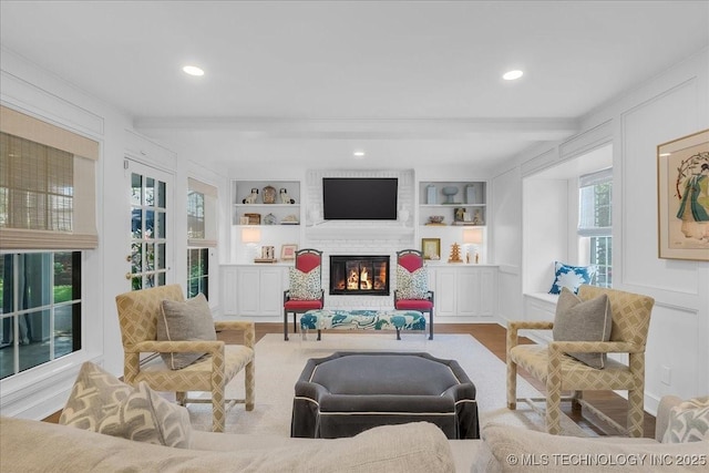 5824 S Louisville Ave, Tulsa, OK 74135 - living room with beamed ceiling, a brick fireplace, built in features, recessed lighting, and wood finished floors