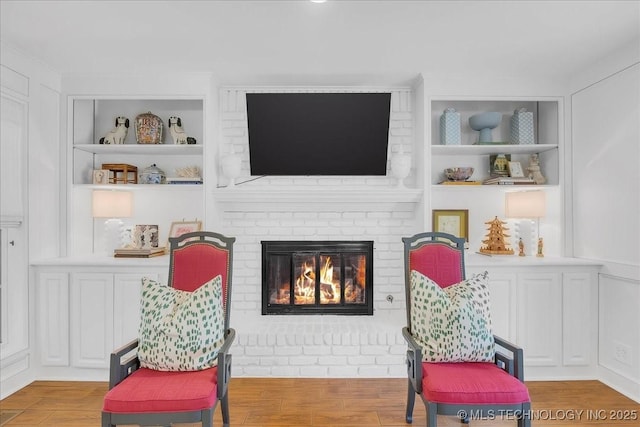 5824 S Louisville Ave, Tulsa, OK 74135 - sitting room with a brick fireplace, wood finished floors, and built in features