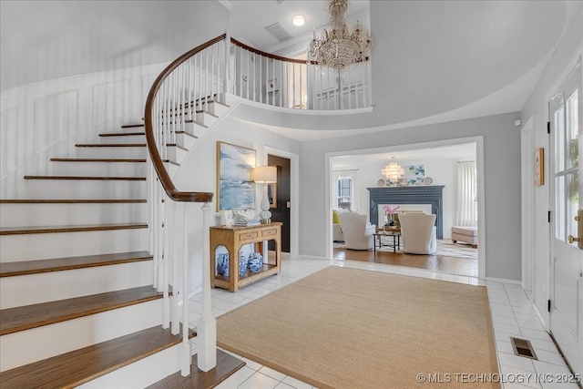5824 S Louisville Ave, Tulsa, OK 74135 - entryway with a chandelier, tile patterned floors, stairway, and a towering ceiling