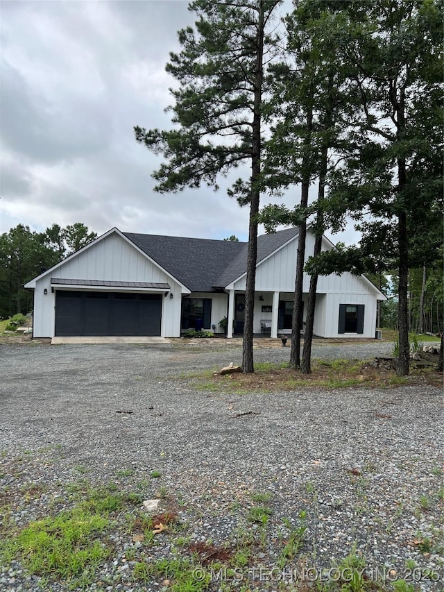 13425 SW 1025th Ave, Tuskahoma, OK 74571 - view of front facade featuring a garage, driveway, board and batten siding, and a shingled roof