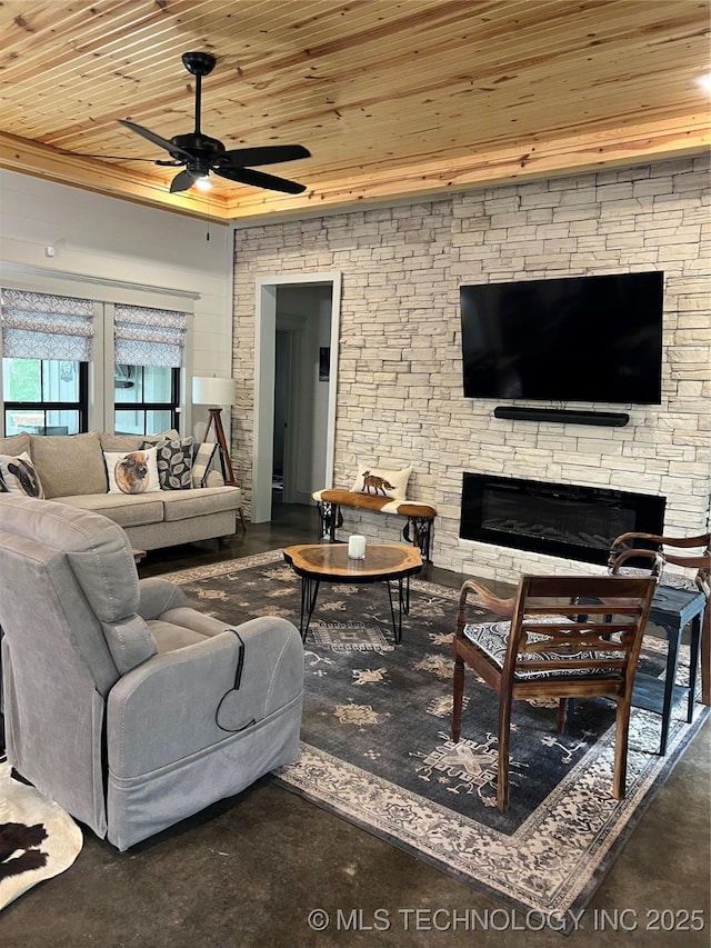 13425 SW 1025th Ave, Tuskahoma, OK 74571 - living area featuring wood ceiling, a ceiling fan, a fireplace, and concrete floors