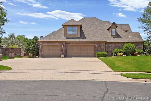 509 E Glendale St, Broken Arrow, OK 74011 - craftsman-style house featuring brick siding, concrete driveway, a front lawn, an attached garage, and roof with shingles