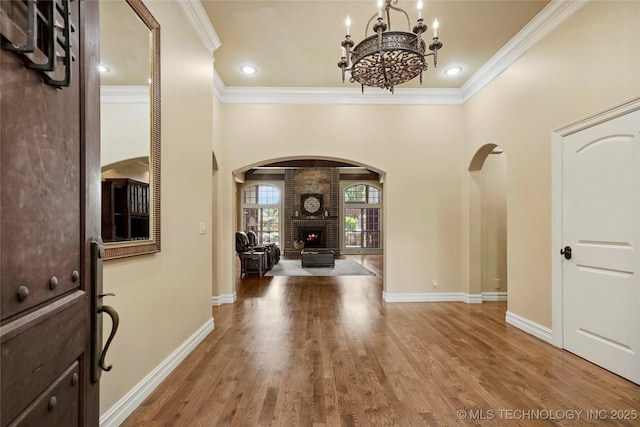 509 E Glendale St, Broken Arrow, OK 74011 - foyer with arched walkways, ornamental molding, a chandelier, wood finished floors, and recessed lighting