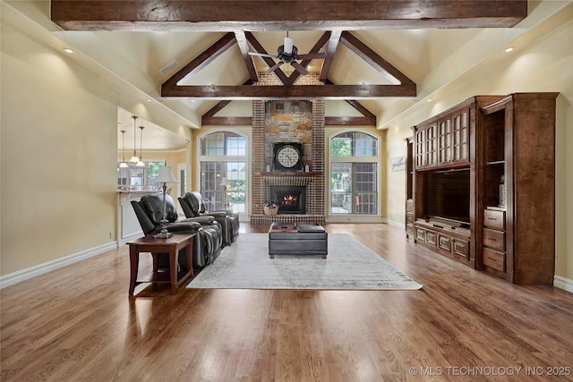 509 E Glendale St, Broken Arrow, OK 74011 - living room featuring beamed ceiling, high vaulted ceiling, wood finished floors, and a brick fireplace