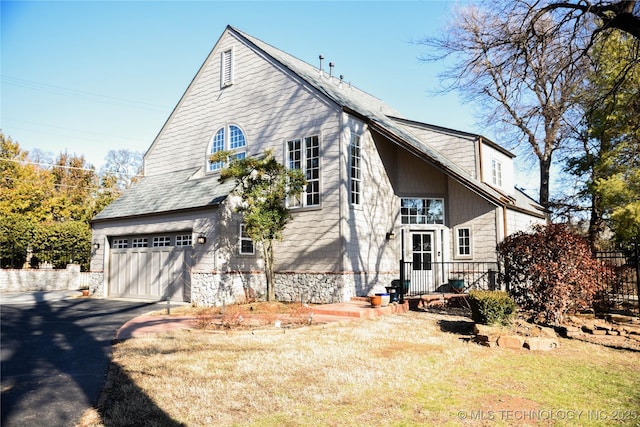 1207 E 21st Pl, Tulsa, OK 74114 - view of home's exterior featuring a garage and driveway