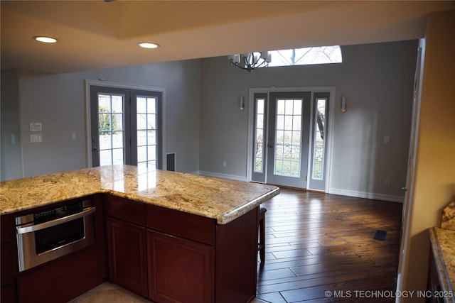 1207 E 21st Pl, Tulsa, OK 74114 - kitchen featuring oven, plenty of natural light, a chandelier, wood finished floors, and recessed lighting