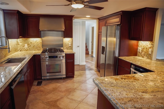 1207 E 21st Pl, Tulsa, OK 74114 - kitchen featuring stainless steel appliances, custom range hood, a ceiling fan, light stone counters, and backsplash