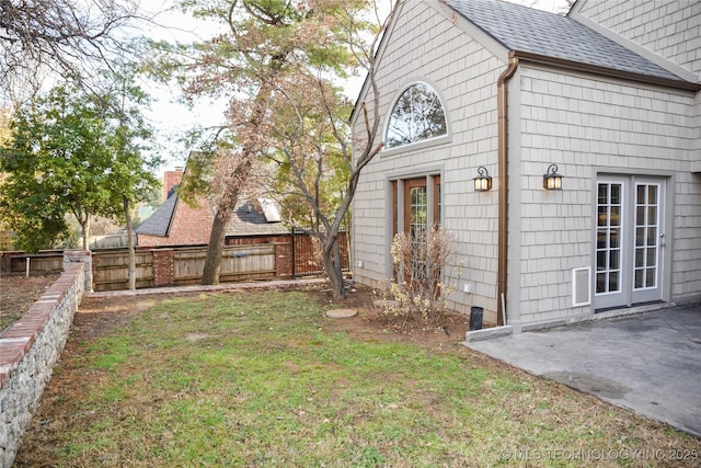 1207 E 21st Pl, Tulsa, OK 74114 - view of side of property with a shingled roof and a patio area
