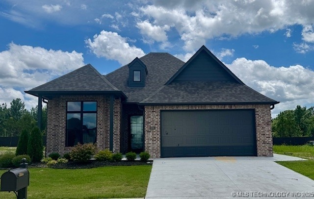 3703 W Laredo Pl, Broken Arrow, OK 74011 - view of front of property featuring brick siding, an attached garage, concrete driveway, and a front lawn