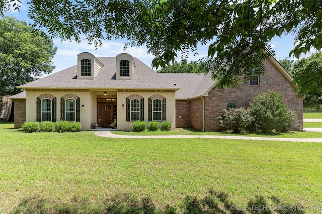 13559 E 463rd Rd, Claremore, OK 74017 - french country style house with a front lawn, roof with shingles, stucco siding, and brick siding