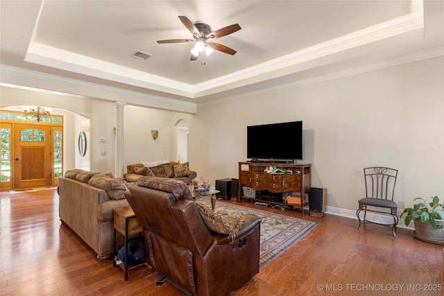 13559 E 463rd Rd, Claremore, OK 74017 - living area featuring arched walkways, a tray ceiling, wood-type flooring, a ceiling fan, and ornamental molding