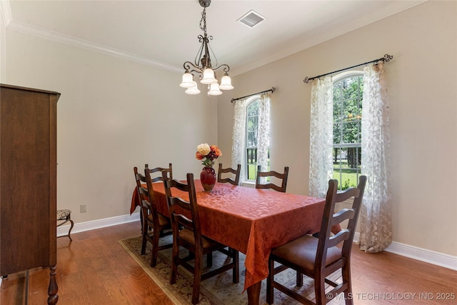 13559 E 463rd Rd, Claremore, OK 74017 - dining space with wood finished floors, ornamental molding, and a chandelier