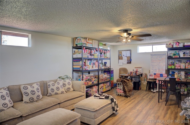 9449 S 74th St W, Oktaha, OK 74450 - living room with wood finished floors, a textured ceiling, and a ceiling fan