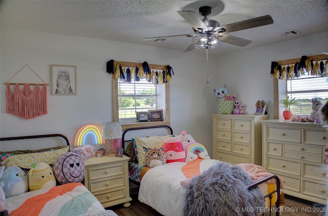 9449 S 74th St W, Oktaha, OK 74450 - bedroom featuring a textured ceiling, dark wood-style flooring, and ceiling fan