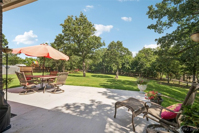 4005 Frontier Rd, Sapulpa, OK 74066 - view of patio / terrace with outdoor dining space and view of wooded area
