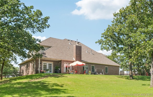 4005 Frontier Rd, Sapulpa, OK 74066 - back of house featuring brick siding, a lawn, roof with shingles, and a chimney