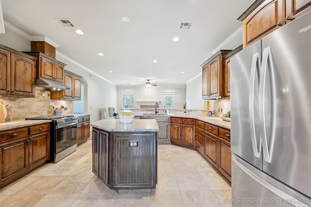 3604 W 109th St S, Jenks, OK 74037 - kitchen with appliances with stainless steel finishes, under cabinet range hood, decorative backsplash, crown molding, and light stone counters