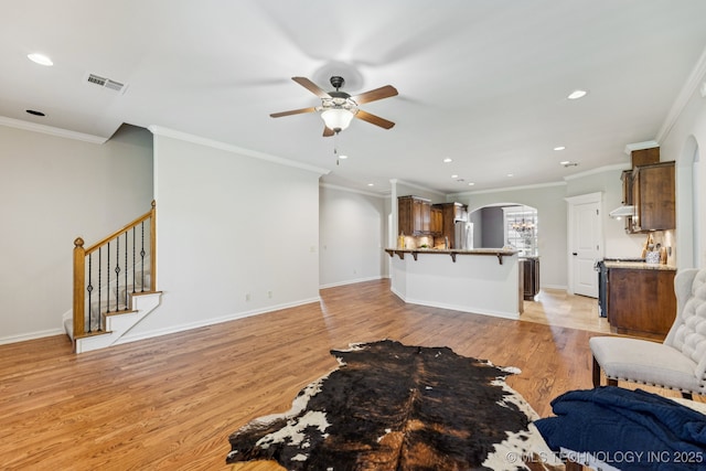 3604 W 109th St S, Jenks, OK 74037 - unfurnished living room featuring arched walkways, ceiling fan, light wood finished floors, recessed lighting, and ornamental molding