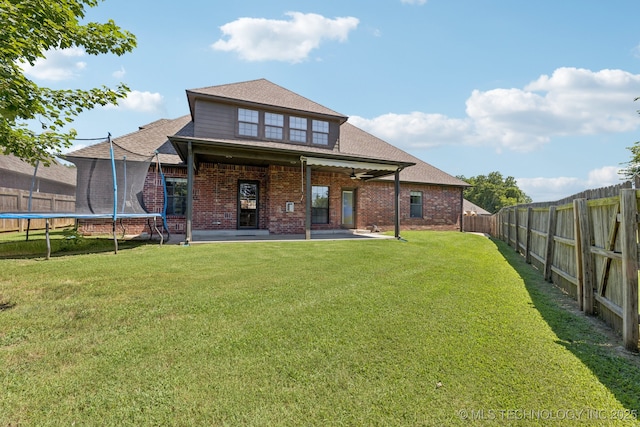 3604 W 109th St S, Jenks, OK 74037 - rear view of house with a trampoline, brick siding, a fenced backyard, and a patio area