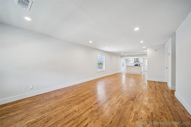241 S Richmond Ave, Tulsa, OK 74112 - unfurnished living room with light wood finished floors and recessed lighting