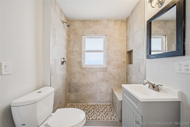 241 S Richmond Ave, Tulsa, OK 74112 - bathroom with tiled shower, vanity, and a textured wall