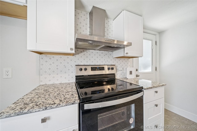 241 S Richmond Ave, Tulsa, OK 74112 - kitchen featuring stainless steel electric range oven, wall chimney range hood, tasteful backsplash, light stone countertops, and white cabinetry