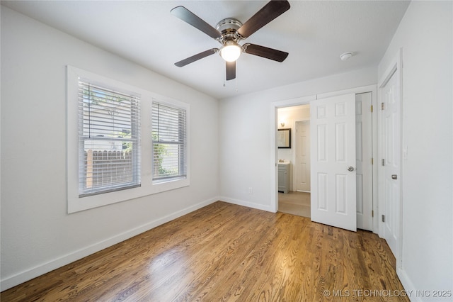 241 S Richmond Ave, Tulsa, OK 74112 - unfurnished bedroom featuring wood finished floors, ensuite bathroom, and a ceiling fan