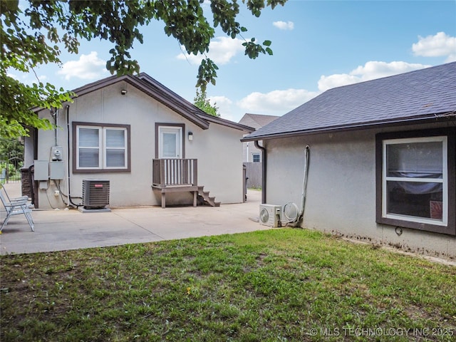 241 S Richmond Ave, Tulsa, OK 74112 - rear view of property featuring stucco siding, a yard, a patio area, and a shingled roof