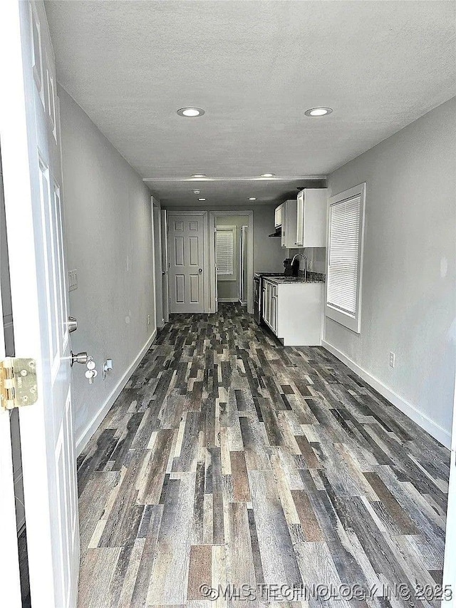 241 S Richmond Ave, Tulsa, OK 74112 - kitchen featuring dark wood-type flooring, dark countertops, white cabinets, a textured ceiling, and recessed lighting