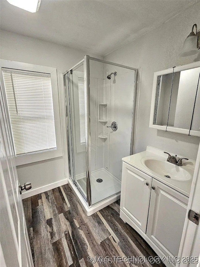241 S Richmond Ave, Tulsa, OK 74112 - full bathroom with a stall shower, wood finished floors, vanity, and a textured ceiling