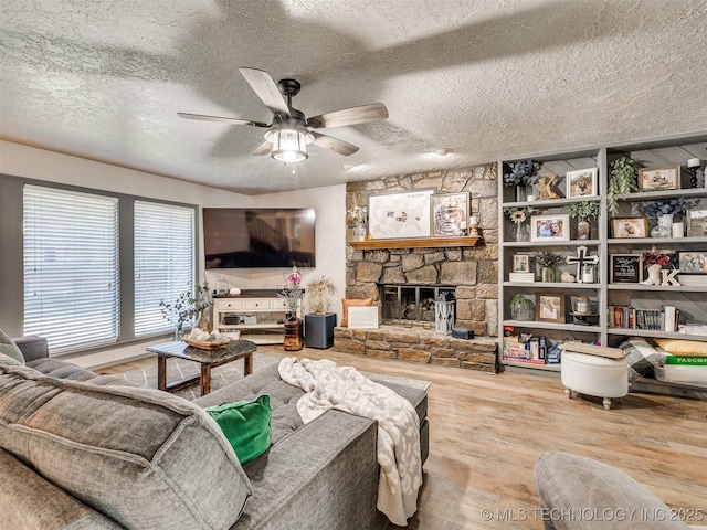 6708 S 5th St, Broken Arrow, OK 74011 - living area with a ceiling fan, wood finished floors, a fireplace, and a textured ceiling