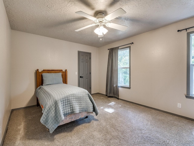 6708 S 5th St, Broken Arrow, OK 74011 - bedroom with multiple windows, carpet flooring, a textured ceiling, and a ceiling fan