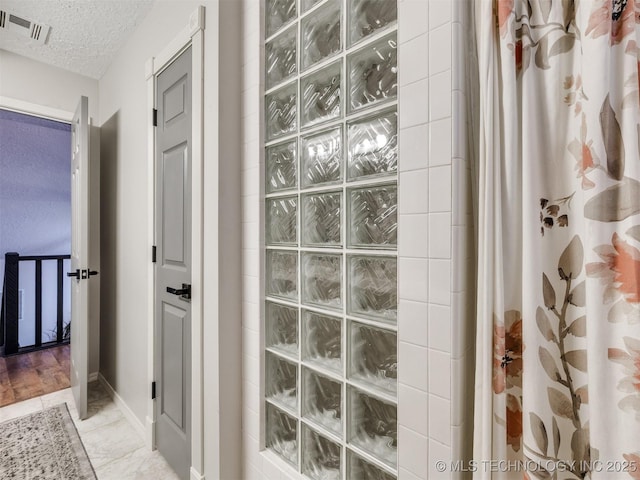 6708 S 5th St, Broken Arrow, OK 74011 - full bathroom with walk in shower and a textured ceiling