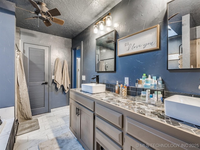 6708 S 5th St, Broken Arrow, OK 74011 - bathroom featuring marble look tile flooring, vanity, a ceiling fan, a shower with shower curtain, and a textured ceiling