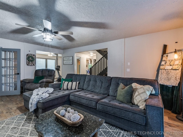 6708 S 5th St, Broken Arrow, OK 74011 - living room featuring wood finished floors, stairway, a ceiling fan, and a textured ceiling