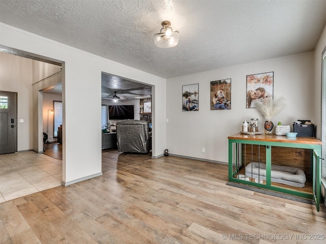 6708 S 5th St, Broken Arrow, OK 74011 - foyer entrance with wood finished floors, a textured ceiling, and a ceiling fan