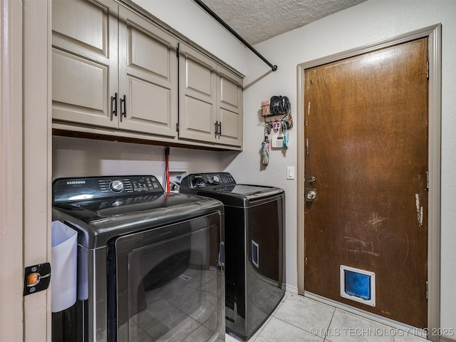 6708 S 5th St, Broken Arrow, OK 74011 - washroom featuring cabinet space, washer and dryer, a textured ceiling, and light tile patterned floors
