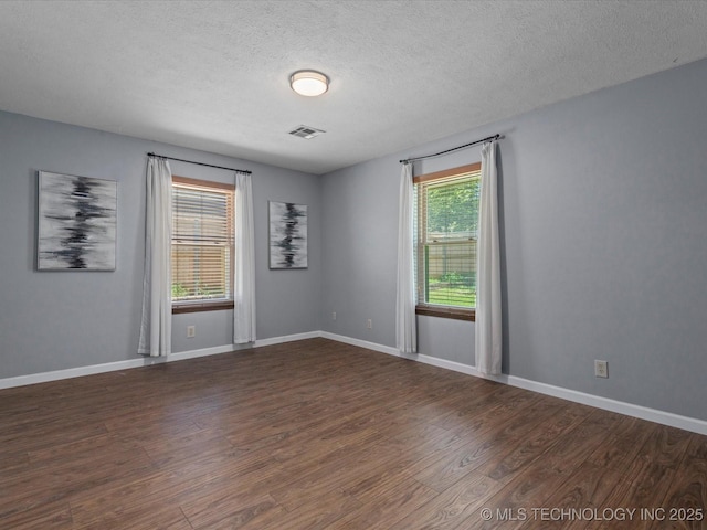 6725 Dorsett Dr, Bartlesville, OK 74006 - spare room featuring dark wood-style floors and a textured ceiling