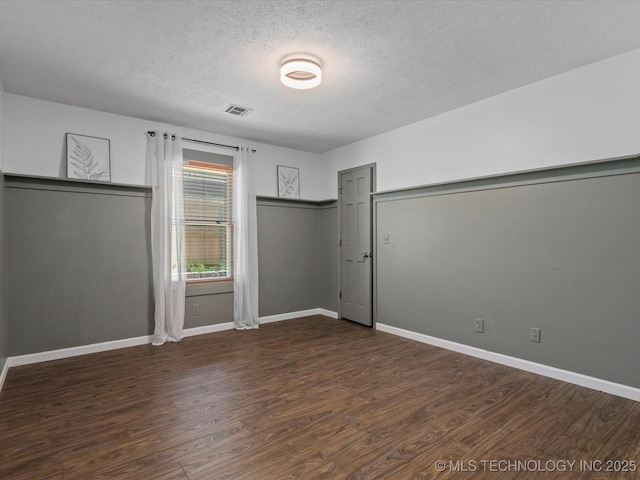 6725 Dorsett Dr, Bartlesville, OK 74006 - unfurnished bedroom with a textured ceiling and wood finished floors