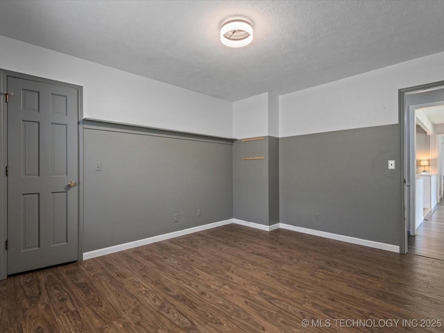 6725 Dorsett Dr, Bartlesville, OK 74006 - empty room with dark wood-style flooring and baseboards