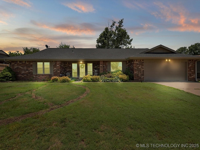6725 Dorsett Dr, Bartlesville, OK 74006 - ranch-style house featuring a garage, driveway, brick siding, and a lawn