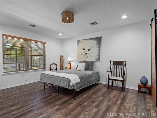 6725 Dorsett Dr, Bartlesville, OK 74006 - bedroom with wood finished floors, a barn door, and recessed lighting