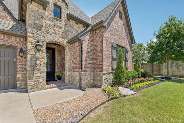 11029 S Kennedy St, Jenks, OK 74037 - property entrance with a high end roof, stone siding, and brick siding