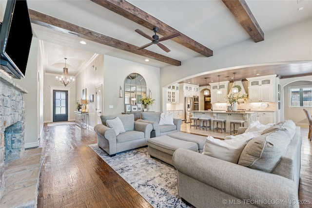 11029 S Kennedy St, Jenks, OK 74037 - living room with arched walkways, light wood-style floors, healthy amount of natural light, a chandelier, and beam ceiling