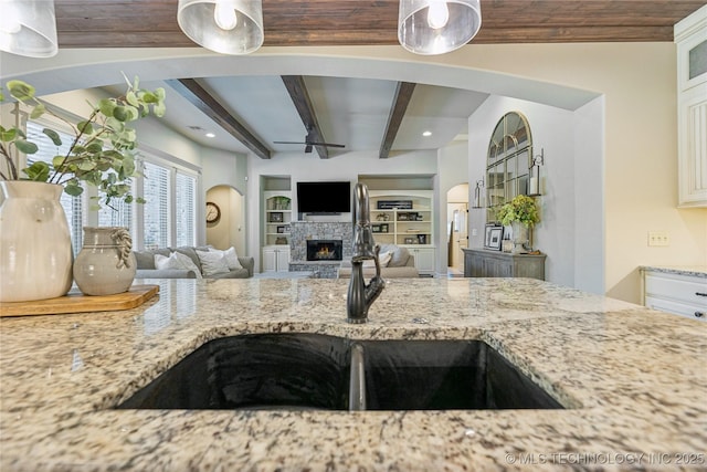 11029 S Kennedy St, Jenks, OK 74037 - kitchen with light stone counters, a ceiling fan, a fireplace, recessed lighting, and open floor plan