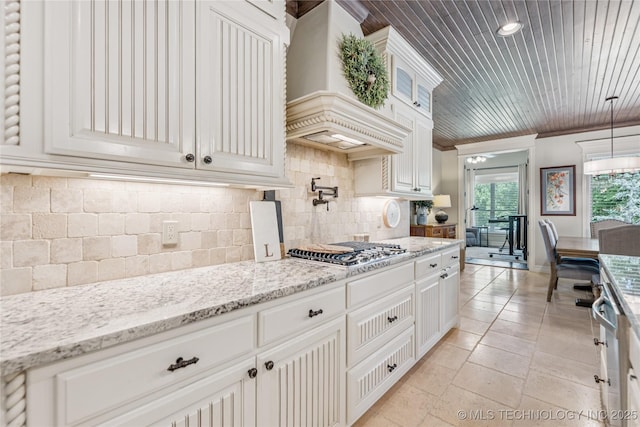 11029 S Kennedy St, Jenks, OK 74037 - kitchen featuring stainless steel gas stovetop, custom exhaust hood, tasteful backsplash, crown molding, and light stone countertops