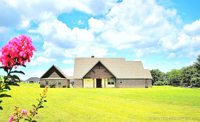 6865 Wilson St, Durant, OK 74701 - view of front facade featuring a front lawn and brick siding